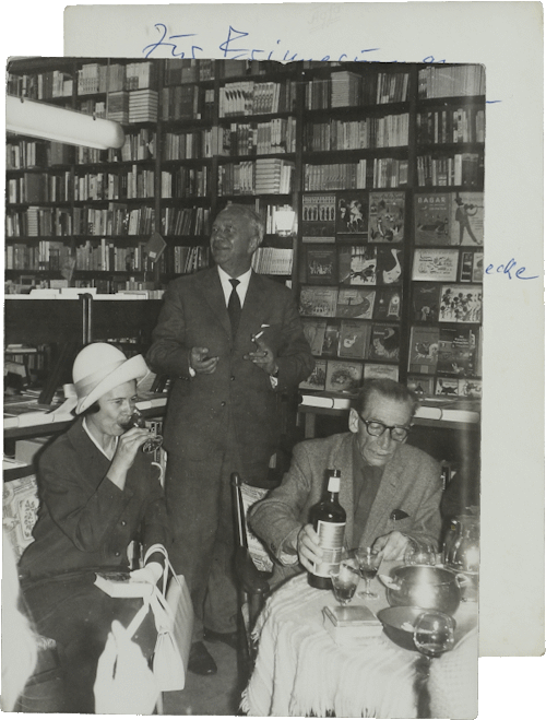 Photo of M. Y. Ben-Gavriêl at a reading in the Thalia bookstore (handwritten dedication on the back), Hamburg, 1965, NLI, Moshe Ya’aqov Ben Gavriel Archive, ARC. Ms. Var. 365 1 33.